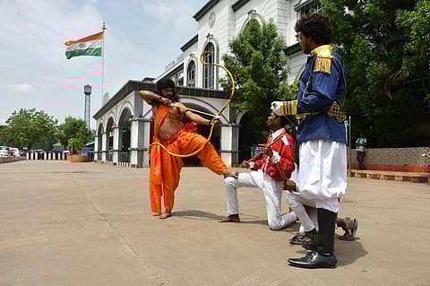 Artists of new star modern theatre arts in Alluri Sitarama Raju and Britishers attire pose for a picture at Vijayawada railway station. (Photo |  Prasant Madugula)