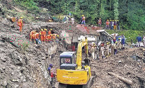 Rescue workers search for people feared missing in landslides in Shimla on Tuesday. (Photo | PTI)
