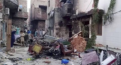 Local residents look damaged furniture outside of a burned church in a Christian neighborhood following an angry Muslim mob attack in Jaranwala near Faisalabad, Pakistan. (Photo | AP)