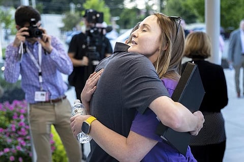 Cobb teacher Katie Rinderle, right, embraces Jack Lakis, a recent Harrison High School graduate, after a Cobb County school board meeting Thursday, Aug. 17, 2023. (Photo | AP)
