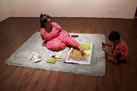 Rajasthan native Saraswathi Sharma creates a landscape painting at Ma Joie art gallery in Fort Kochi. (Photo | Express)