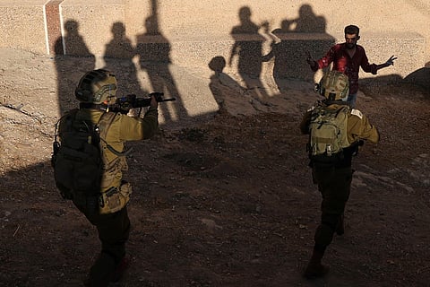 Israeli soldiers approach a Palestinian man during a search operation in Baita village in the occupied West Bank, on August 21, 2023. (Photo | AFP)