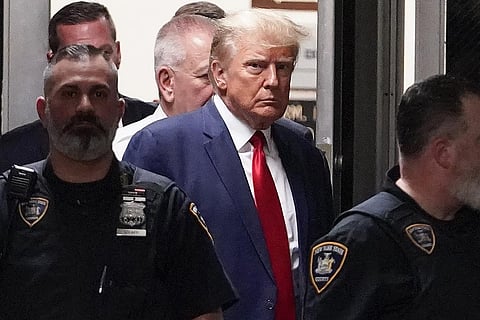FILE - Former President Donald Trump is escorted to a courtroom, April 4, 2023, in New York. (Photo | AP)