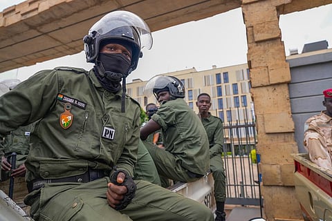 Nigerien police officers sit outside the customs offices in Niamey, Niger, Monday, Aug. 21, 2023.  (Photo | AP)