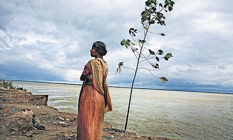 Puspa Rani Roy at the edge of her land.