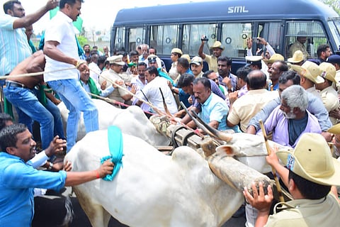 Police detain farmers who tried to block the Bengaluru-Mysuru highway in Mandya district on Tuesday | Express