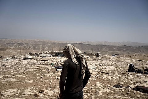 A Palestinian shepherd stands in the ruins of the West Bank Bedouin village of al-Baqa where residents fled in July after settlers established an outpost near the village,  Aug. 9, 2023. (Photo | AP)