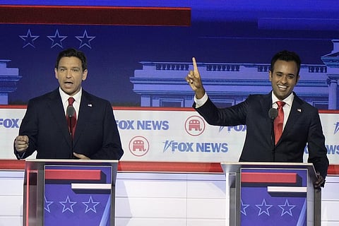 Florida Gov. Ron DeSantis and businessman Vivek Ramaswamy talk at the same time during the GOP presidential primary debate in Milwaukee, Aug 23, 2023. (Photo | AP)