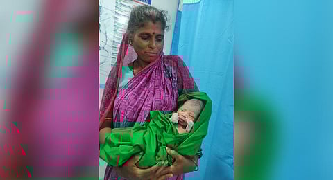 An attendant holding Ranu Mallick’s son at the hospital | EXPRESS