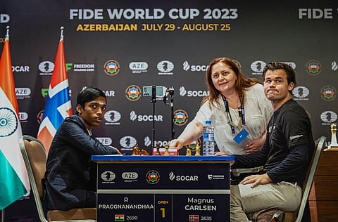 Aynur Sofiyeva, Azerbaijan's first Woman Grandmaster, makes the ceremonial first move in the second game between Norway's GM Magnus Carlsen and India's GM R Praggnanandhaa. (Photo | PTI)