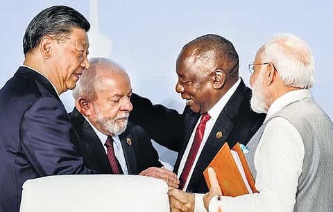 Chinese President Xi Jinping shakes hands with Prime Minister Narendra Modi during the 2023 BRICS Summit in Johannesburg on Thursday, August 24, 2023. (Photo| AFP)