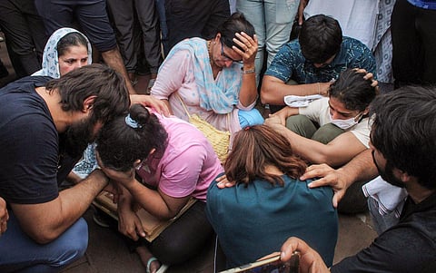 FILE - Protesting wrestlers Sakshi Malik, Vinesh Phogat and Sangeeta Phogat sit at Har ki Pauri ghat, in Haridwar, Tuesday, May 30, 2023. (Photo | PTI)