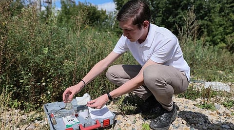 Alexei Zetkin testing water released by a paper factory on the bank of the Sura river in Penza. (Photo | AFP)