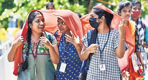 Students cover their faces with a shawl to beat the heat in Chennai | P Jawahar 