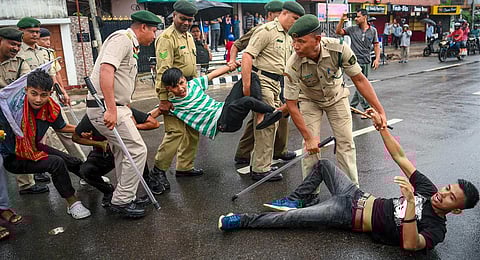 Police detain students at a protest during a 12-hour statewide bandh called by Twipra Students' Federation  demanding adoption of Roman script for Kokborok language, in Agartala, Aug. 28, 2023. (PTI)