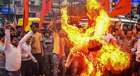 Vishva Hindu Parishad (VHP) and Bajrang Dal supporters burn an effigy during a protest against the violence in Haryana's Nuh district. (Photo | PTI)