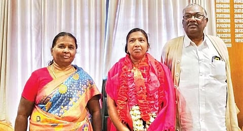 Jeyalakshmi with her father Palanivel and mother after being sworn in  as Devikulam block panchayat president on Tuesday. (Photo | Express)