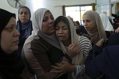 Mourners cry after taking the last look at the body of Mahmoud Abu Saan at a mosque during his funeral in the West Bank city of Tulkarem, Aug 4, 2023. (Photo | AP)