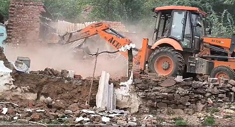The district administration on Saturday morning razed houses and shops of local residents in Haryana's Nuh. (Photo | Videograb)