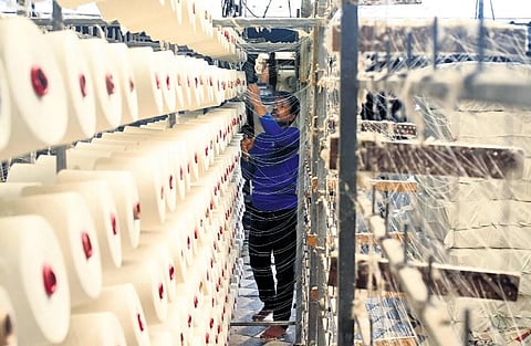 A weaver working with corn yarn at Balaramapuram. (Photo | Express)