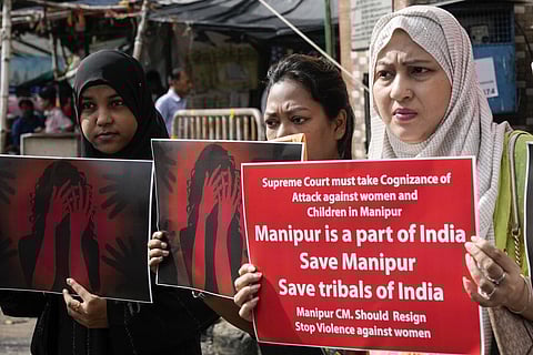 Women activists carry posters at a gathering protesting against ethnic violence in the northeastern state of Manipur, in Kolkata, India, Wednesday, July 26, 2023. (AP)