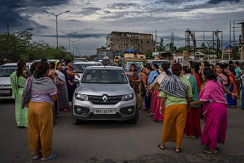 Members of Meira Paibis block traffic as they check vehicles for the presence of members from rival Christian tribal Kuki community, in Manipur. (Photo | AP)