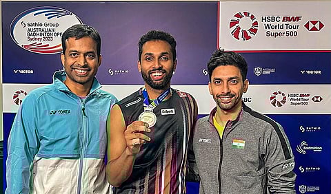 Badminton player HS Prannoy with coach P Gopichand (L) poses for pictures with silver medal after the Australian Open men's singles final at the State Sports Centre in Sydney. (Photo | PTI)