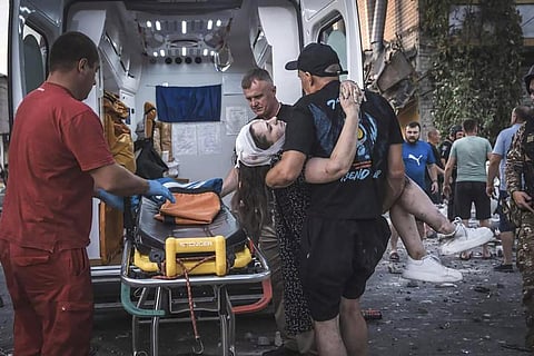 People carry a wounded person from a damaged building after Russian missile strikes in Pokrovsk, Donetsk region, Ukraine, Monday, Aug. 7, 2023. (Photo | AP)