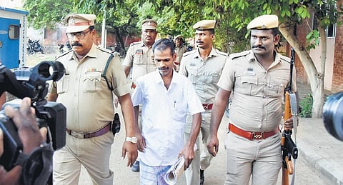 Serial killer Sappani being escorted out of court after the verdict in Tiruchy on Monday | MK Ashok Kumar