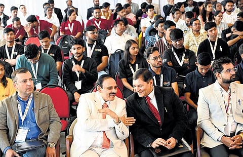AMC College Chairman KR Paramahamsa has a word with NAAC Senior Adviser MS Shyamsundar at the inauguration of Kavach 2023, in Bengaluru on Tuesday | Express