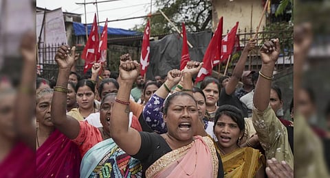 Women raise slogans during a protest against the proposed Dharavi redevelopment project of Adani Group that seeks to transform one of the world's largest slums, in Mumbai. (Photo | PTI)