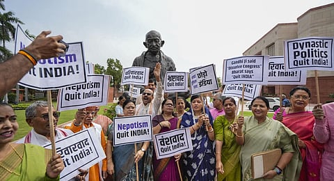 BJP MPs raise slogans during a demonstration at the Parliament House complex to mark the 'Quit India Movement Day' during Monsoon session.(Photo | PTI)