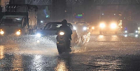Vehicles wayed through a flooded road during heavy rain in Bengaluru on Thursday evening | Express