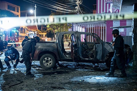 Police inspect a truck that exploded outside an office used by the government's National Service for Attention for People Deprived of Liberty. (Photo | AP)