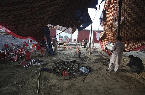 FILE- Shoes of victims are gathered after Sunday's suicide bomber attack, in the Bajur district of Khyber Pakhtunkhwa, Pakistan, Monday, July 31, 2023. (Photo | AP)