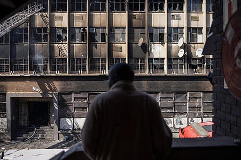 A nighttime fire ripped through a rundown five-story building in Johannesburg that was occupied by homeless people and squatters, killing over 70 people early Thursday. (Photo | AP)