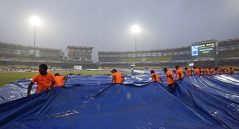 Ground staff pull covers as it rains during the Asia Cup cricket match between India and Pakistan in Colombo, Sri Lanka, Sunday, Sept.10, 2023.(Photo | AP)