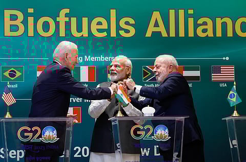 US President Joe Biden, left, Indian Prime Minister Modi, center, and Brazilian President Luiz Inacio Lula da Silva hold hands at the launch of the Global Biofuels Alliance at the G20 summit. (PTI)