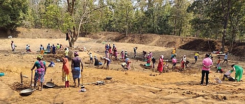 Workers constructing canals under the project