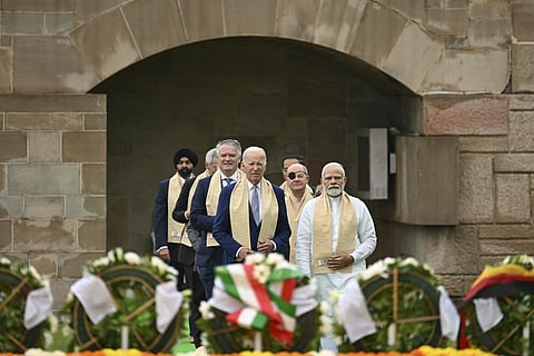 U.S. President Joe biden, center left, with Indian Prime Minister Narendra Modi, right, and other G20 leaders arrive to pay their respects at the Rajghat, a Mahatma Gandhi memorial, in New Delhi, Indi