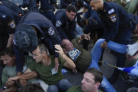 Israeli police disperse demonstrators, mostly military reservists, who block a road outside the house of Justice Minister Yariv Levin, Sept 11, 2023. (Photo | AP)