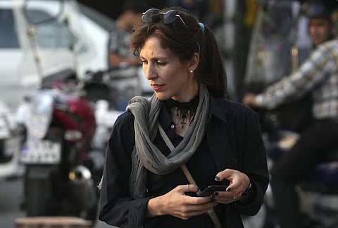An Iranian woman without wearing her mandatory Islamic headscarf walks in downtown Tehran, Iran. (Photo | AP)