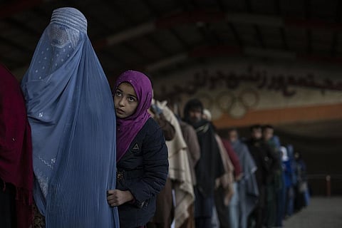 Women queue to receive cash at a money distribution site organized by the World Food Program in Kabul, Afghanistan. (Photo | AP)