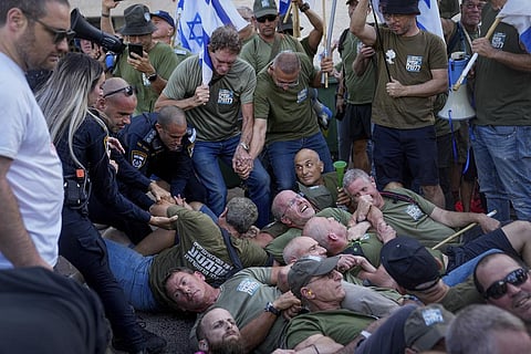 FILE - Israeli military reservists protest outside the house of Israeli Justice Minister Yariv Levin, in Modiin, against the government's judicial reforms, Sept. 11, 2023. (Photo | AP)