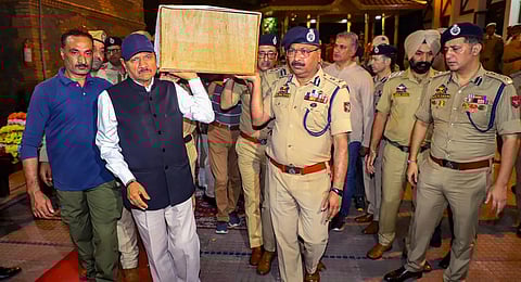 Jammu and Kashmir DGP Dilbag Singh with other police officers carry the mortal remains of Deputy Superintendent of Jammu and Kashmir Police Humayun Bhat.(Photo | PTI)