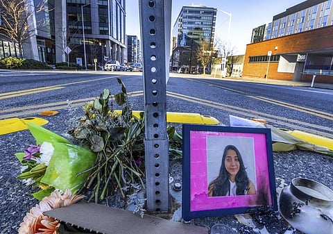 A photo of Jaahnavi Kandula is displayed at the intersection where she was killed by a Seattle Police officer driving north while responding to a nearby medical incident. (Photo | AP)