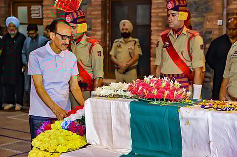 Retd. IG of J&K Police Ghulam Hassan Bhat pays homage to his son and DSP Humayun Bhat who was killed in a gunfight with terrorists in Anantnag, Sept. 13, 2023. (Photo | PTI)