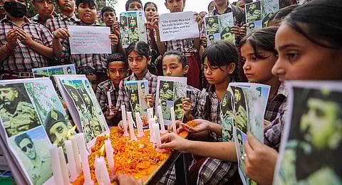 School students pay tribute to 3 Army men who were killed in a gunfight with terrorists in J&K's Anantnag district. (Photo | PTI)