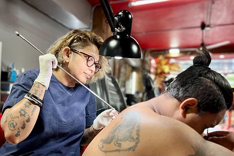 Syama Devi of Dreamcatcher Tattoo Studio doing a bamboo hand-poke tattoo. (Photo | Express)