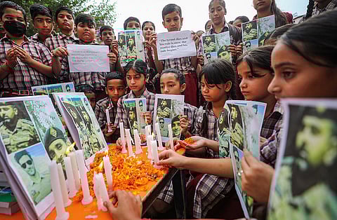 School students pay tribute to 3 Army men who were killed in a gunfight with terrorists in J&K's Anantnag district, in Jammu. (PTI)